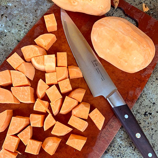 Cut Sweet Potatoes with a Cangshan Cutlery Knife ready to be cooked for Asian Sweet Potato Salad